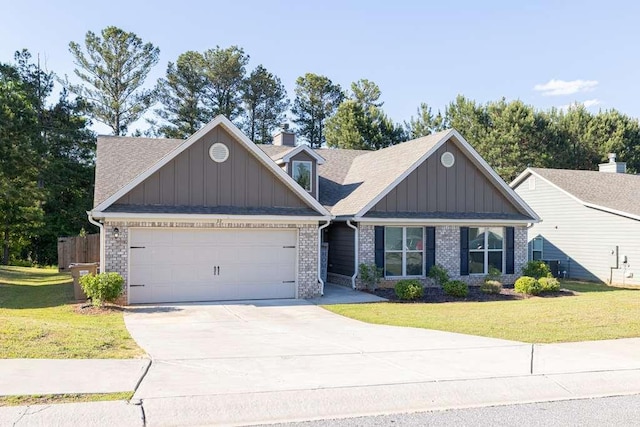 craftsman-style home with board and batten siding, an attached garage, a front lawn, and concrete driveway