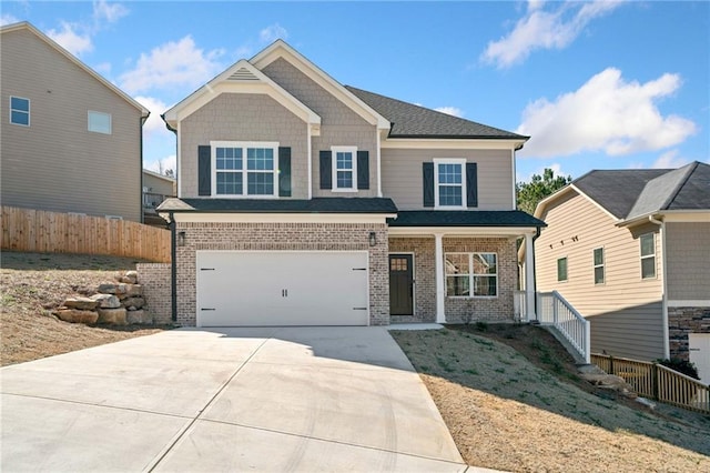 craftsman-style house featuring a garage, concrete driveway, brick siding, and fence