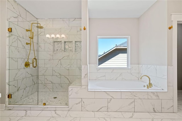 bathroom with marble finish floor, a stall shower, and a bath