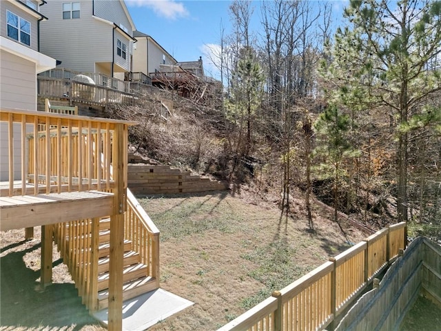 view of yard with a wooden deck and stairs