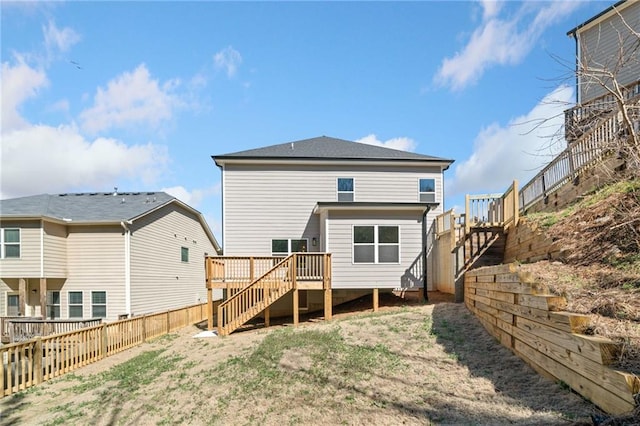 back of house featuring a fenced backyard, stairs, and a deck