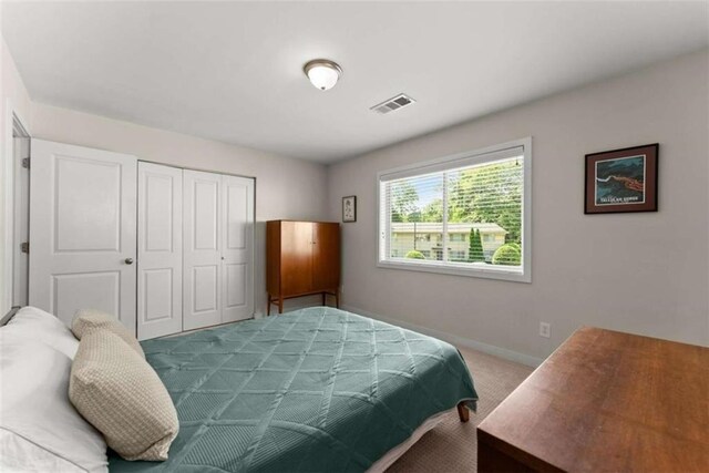 449 Clairemont Ave Unit H3, Decatur, GA 30030 - carpeted bedroom featuring a closet and baseboards