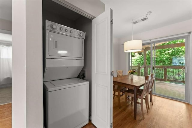 449 Clairemont Ave Unit H3, Decatur, GA 30030 - laundry area with stacked washer and clothes dryer and wood finished floors