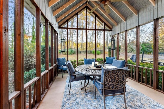 sunroom / solarium featuring vaulted ceiling with beams and ceiling fan