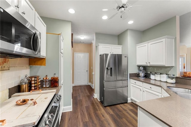 kitchen featuring ceiling fan, tasteful backsplash, dark hardwood / wood-style floors, white cabinets, and appliances with stainless steel finishes