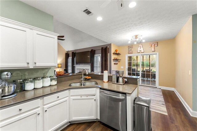 kitchen featuring kitchen peninsula, white cabinetry, dishwasher, and sink