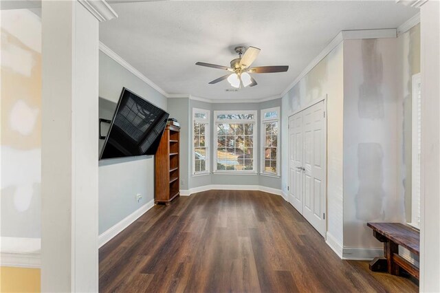 interior space with dark hardwood / wood-style floors, ceiling fan, and crown molding