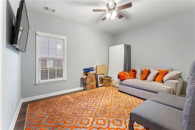 living room featuring wood-type flooring and ceiling fan