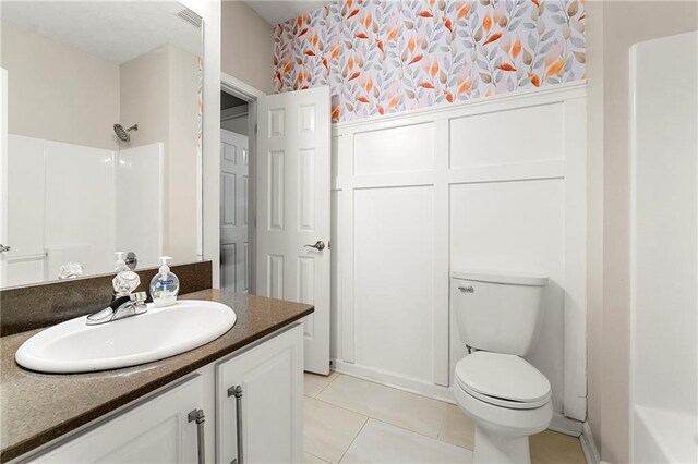 bathroom with tile patterned floors, vanity, and toilet