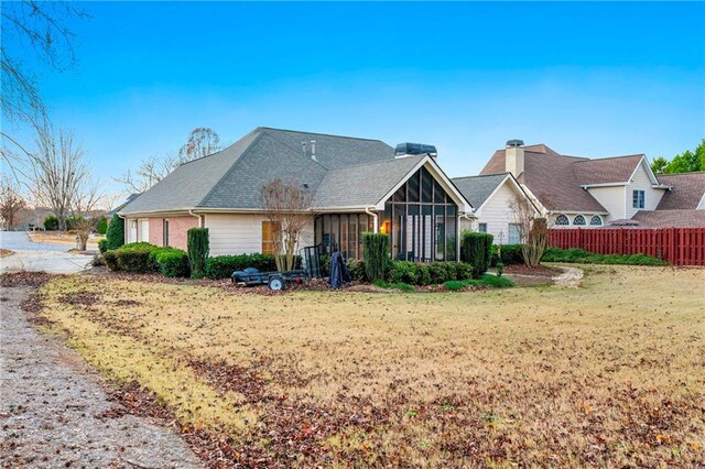 view of front of property with a front lawn and a sunroom