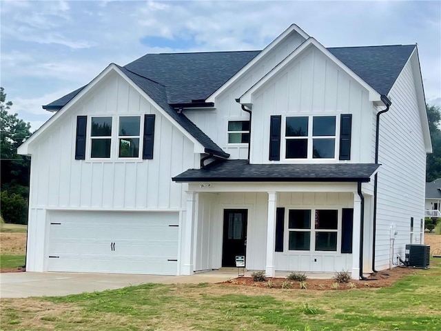 modern farmhouse style home with central AC unit, a garage, and a front lawn