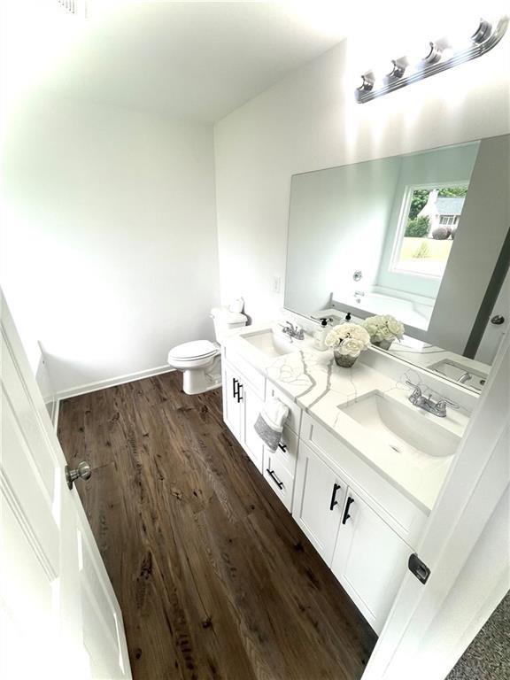 bathroom featuring hardwood / wood-style floors, vanity, and toilet
