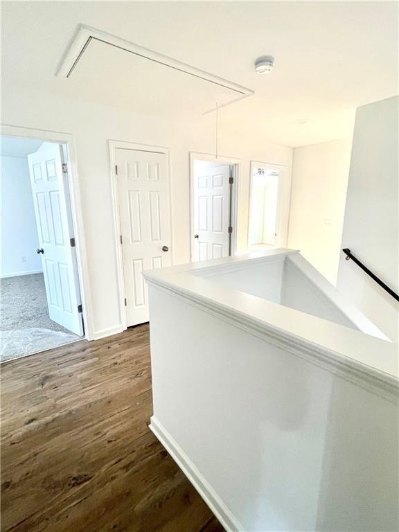 hallway with dark hardwood / wood-style floors