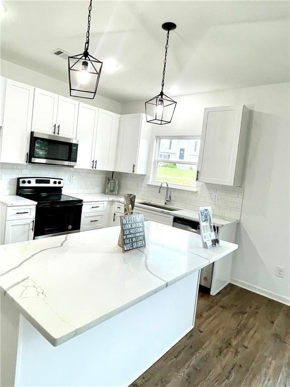 kitchen with white cabinetry, sink, and appliances with stainless steel finishes