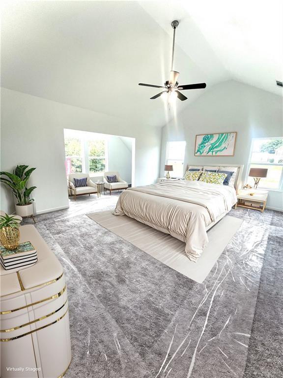 carpeted bedroom featuring ceiling fan and lofted ceiling