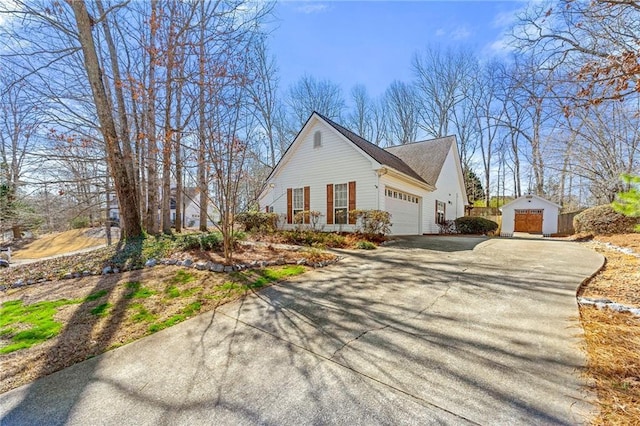 view of property exterior with an attached garage and aphalt driveway