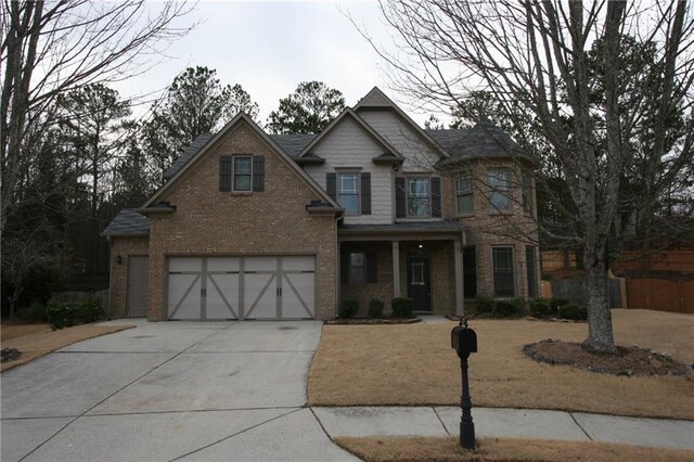 view of front of property with a garage and a front lawn