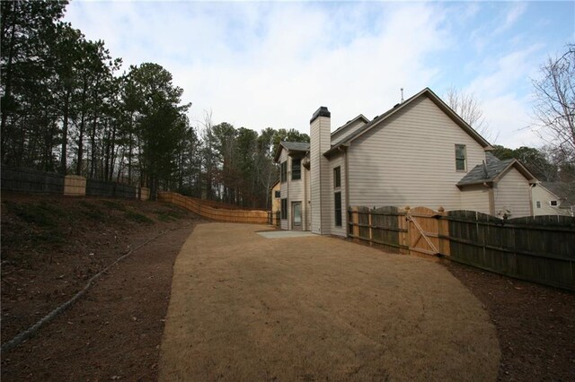 view of front of house with a garage, central AC unit, and a front lawn