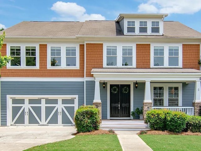 view of front of property featuring a garage and a front yard