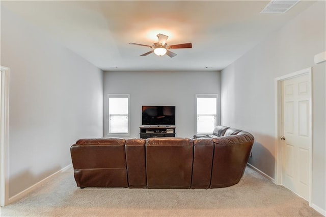 carpeted living room with ceiling fan