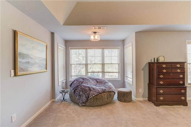 living area featuring light carpet