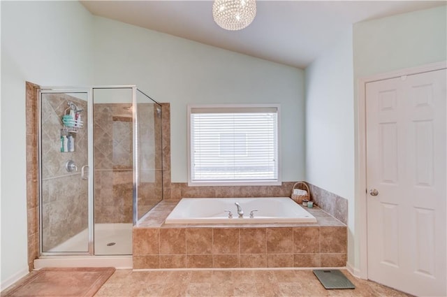 bathroom with shower with separate bathtub, lofted ceiling, and tile patterned floors