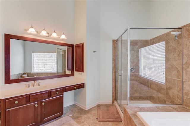 bathroom featuring a towering ceiling, vanity, and separate shower and tub