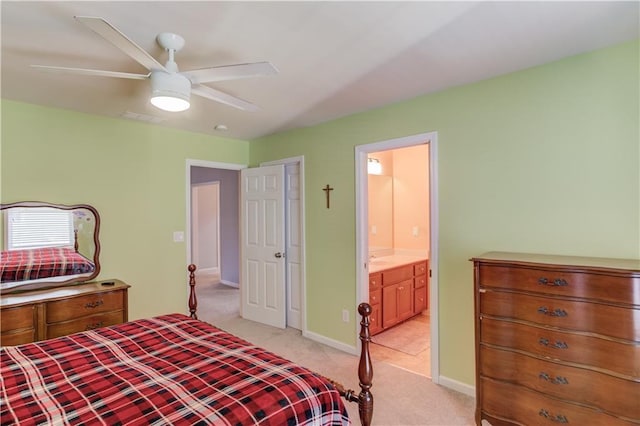 carpeted bedroom with ceiling fan and connected bathroom