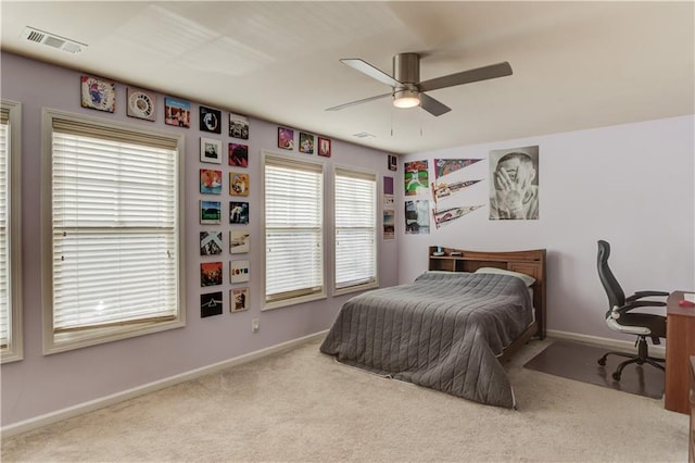 bedroom featuring light colored carpet and ceiling fan