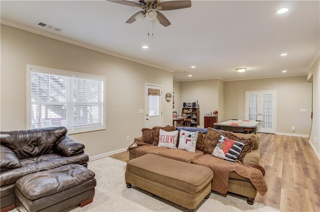 living room featuring ornamental molding, french doors, ceiling fan, and light wood-type flooring