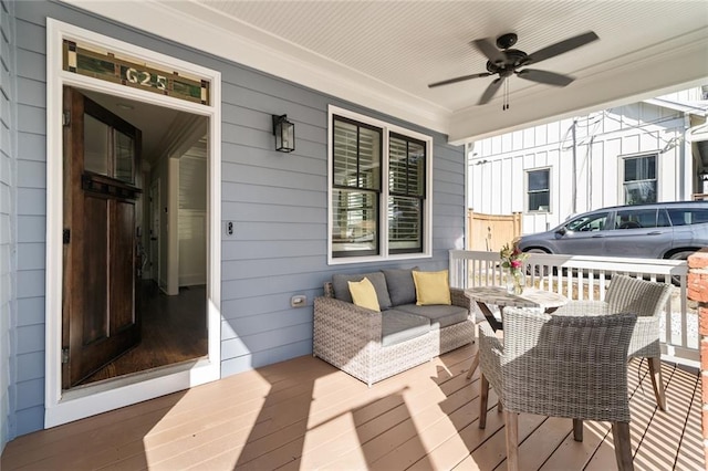 wooden terrace with covered porch and ceiling fan