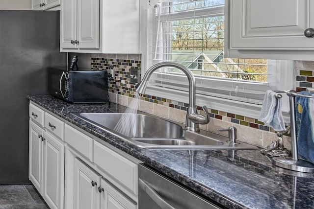 kitchen with backsplash, white cabinets, a sink, black microwave, and dishwasher