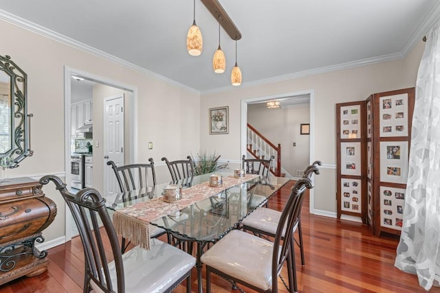 dining room with baseboards, crown molding, hardwood / wood-style floors, and stairs