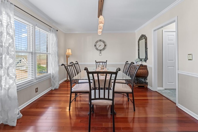 dining space featuring baseboards, ornamental molding, and hardwood / wood-style floors