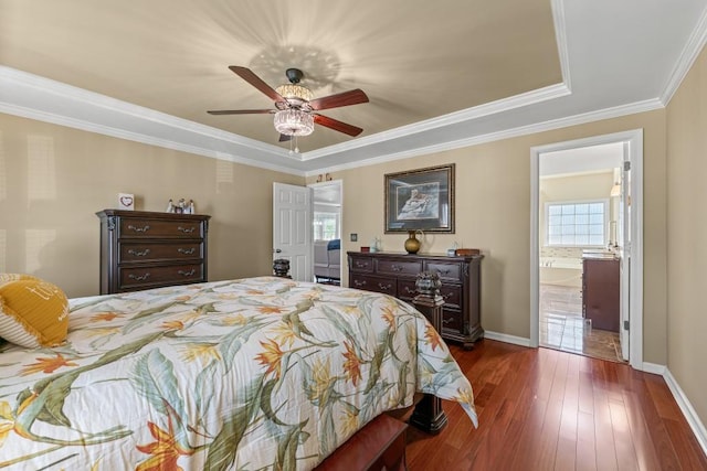 bedroom featuring ceiling fan, dark wood-type flooring, baseboards, ornamental molding, and ensuite bath