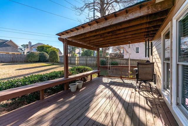 wooden terrace with a lawn and a fenced backyard