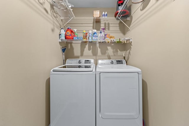 clothes washing area with laundry area and washer and dryer