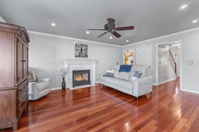 living room with recessed lighting, wood-type flooring, a fireplace, and baseboards