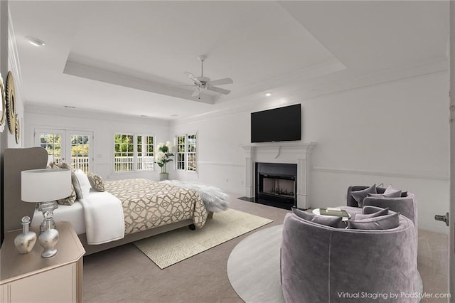 bedroom featuring french doors, a raised ceiling, ceiling fan, and carpet flooring