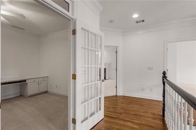 corridor featuring hardwood / wood-style floors and ornamental molding