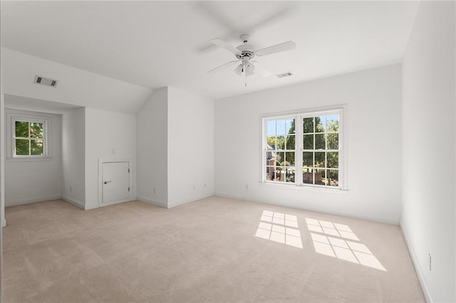 carpeted empty room with ceiling fan and lofted ceiling