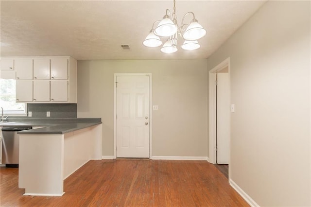 10 Briarcliff Pl, Stockbridge, GA 30281 - kitchen featuring stainless steel dishwasher, wood finished floors, and white cabinetry