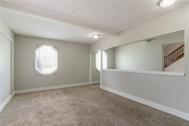 10 Briarcliff Pl, Stockbridge, GA 30281 - spare room featuring carpet flooring, beam ceiling, and a textured ceiling
