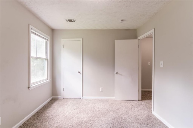 10 Briarcliff Pl, Stockbridge, GA 30281 - unfurnished bedroom featuring carpet flooring, a textured ceiling, and a closet