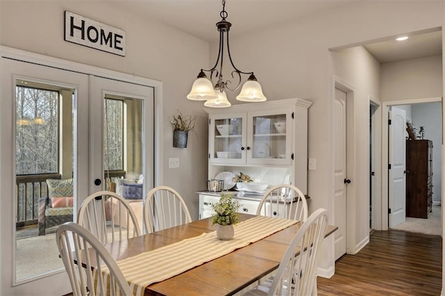 dining area featuring a chandelier, dark hardwood / wood-style floors, and french doors