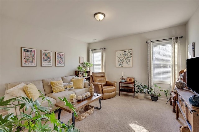 carpeted living room featuring plenty of natural light