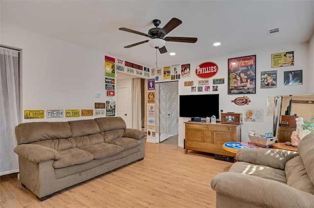 living room featuring ceiling fan and light hardwood / wood-style flooring