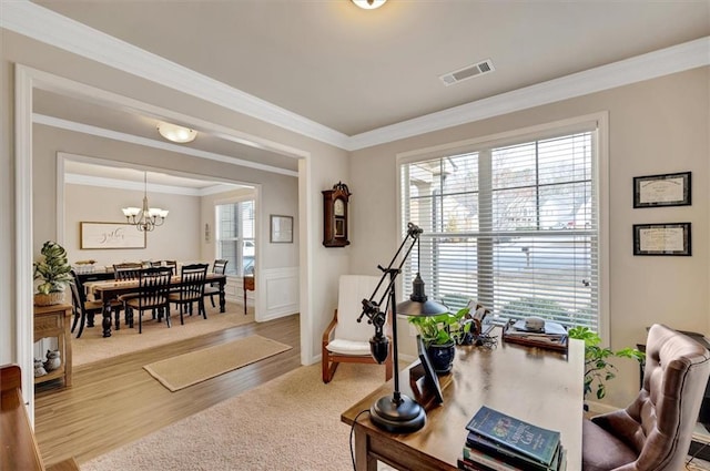 interior space featuring wood-type flooring, crown molding, and an inviting chandelier