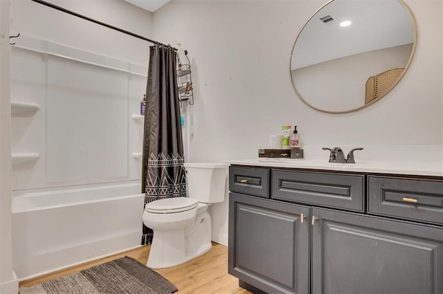 full bathroom featuring vanity, toilet, hardwood / wood-style floors, and shower / bathtub combination with curtain