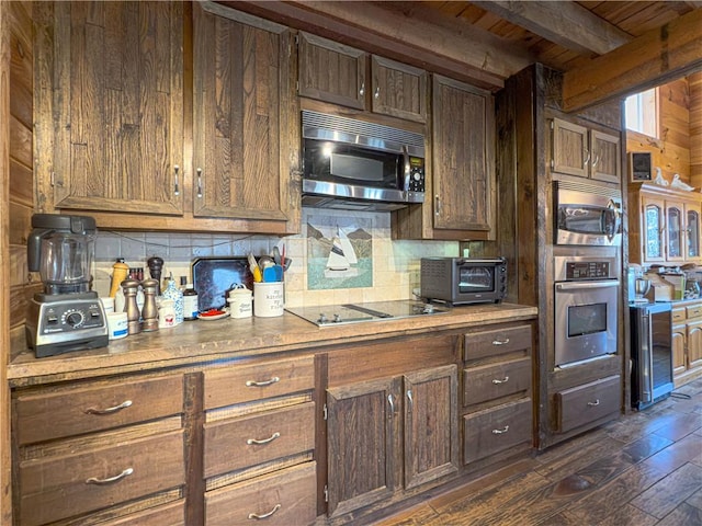 kitchen featuring tasteful backsplash, dark wood finished floors, wooden ceiling, appliances with stainless steel finishes, and beam ceiling